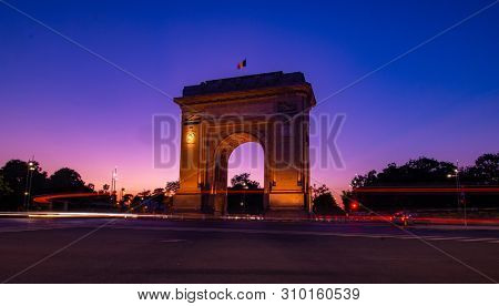 Arc de Triumf in Bucharest Romania at the sunset hour