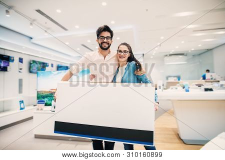 Happy Young Lovely Modern Couple With Bought Big Tv In The Elect