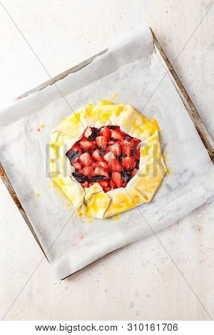 Homemade Strawberry Open Cake Of Gallet With Purple Basil And Balsamic Sauce Before Baking On A Ligh