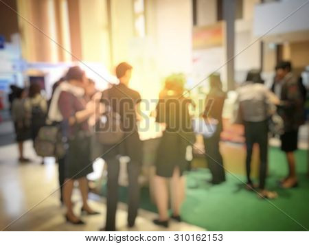 Blurred Image Of People Walking On A Trade Fair Exhibition Or Expo Where Business People Show Innova