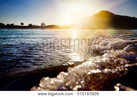 Stunning Sunset On The Beach Of Noja With Infinite Horizon And Solitary Figures In The Distance. Foa