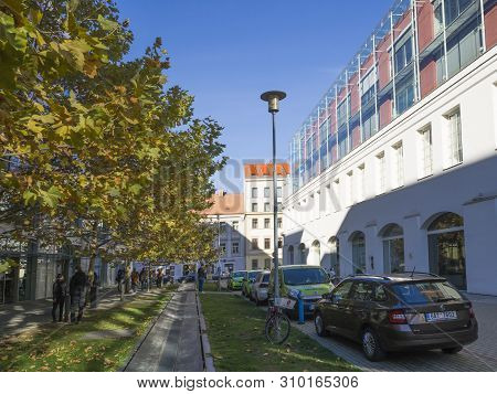 Prague, Czech Republic, April 13, 2019: View Of Office Complex Corso Karlin With Parked Cars, People