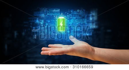 Elegant hand holding battery with full of energy