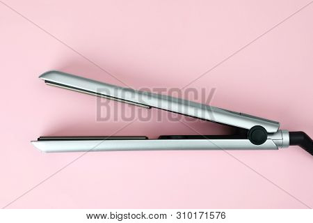 Modern Hair Iron For Straightening On Color Background, Top View