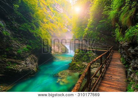 Famous And Popular Touristic Attraction Near Bled. Picturesque Vintgar Gorge With Wooden Footbridge 
