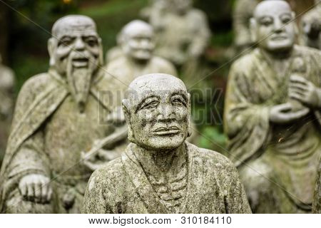groups of buddhist arhat stone statue in the garden