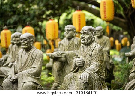 groups of buddhist arhat stone statue in the garden