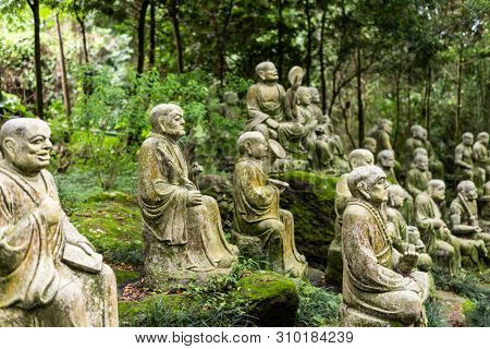 groups of buddhist arhat stone statue in the garden
