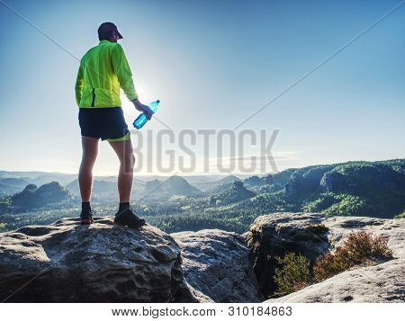 Sports Bottle Drink Sport Man Drinking Water On Trail Run. Male Runner Sweaty And Thirsty After Diff