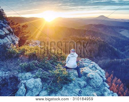 Woman Photographer Works. Professional Artist Takes Photos With Mirror Camera And Tripod On Peak Of 