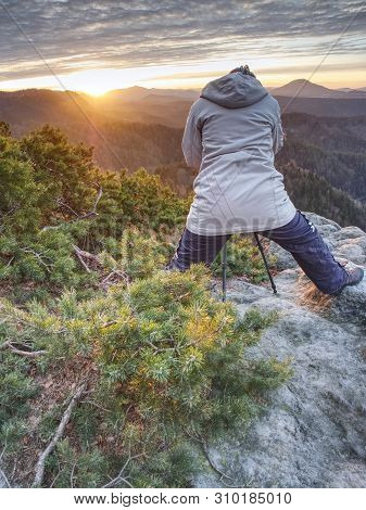 Woman Photographer Works. Professional Artist Takes Photos With Mirror Camera And Tripod On Peak Of 