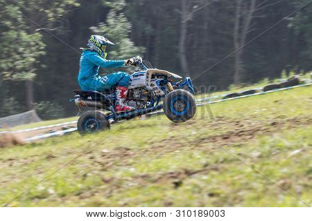 Brezova Nad Svitavou, Czech Republic - June 15, 2019: Panning Shot Of Quad Rider In Blue Driving In 