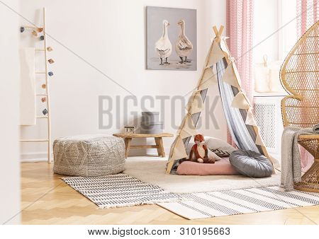 Wicker Peacock Chair Next To Tent With Pillows And Pouf In Scandinavian Designed Girl's Playroom, Re