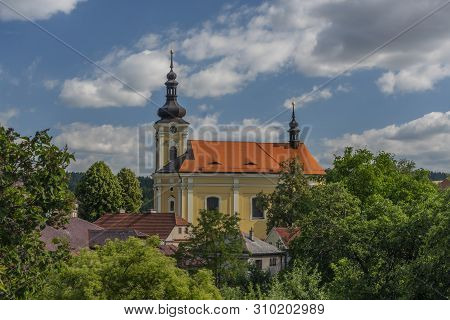 Old Color Church With Red Roof In Pecka Town In Hot Summer Sunny Nice Day