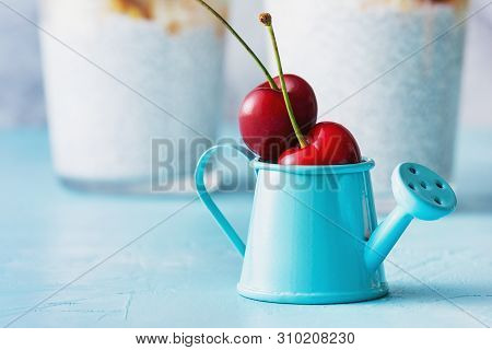 Mini Blue Watering Can With Two Ripe Cherry Fruit. Small Decorative Pot With Red Berry. Tiny Still D