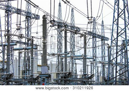 Steel Masts Of High Voltage Power Lines At The Plant. Electrical Substation, Power Converter, High V