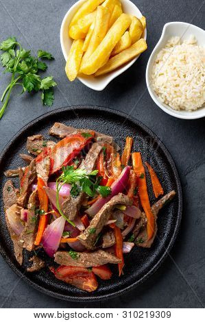 Peruvian Dish Lomo Saltado - Beef Tenderloin With Purple Onion, Yellow Chili, Tomatoes Served Onvbla