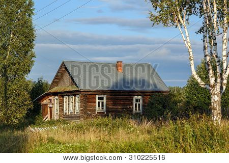 Russian Village In Summer. Old Log House With A Courtyard Overgrown With Grass. Village Of Visim, Sv