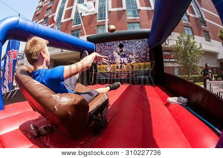 Atlanta, Ga / Usa - August 25:  A Teenage Boy Sits In A Leather Recliner That Moves And Jerks Sporad