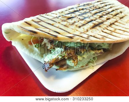 Spicy Turkish Doner Kebab Filled With Roasted Meat, Fresh Salad  And Garlic Sauce In Toasted Tortill