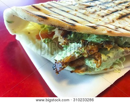 Spicy Turkish Doner Kebab Filled With Roasted Meat, Fresh Salad  And Garlic Sauce In Toasted Tortill