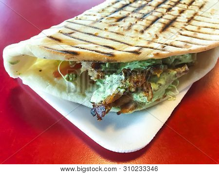 Spicy Turkish Doner Kebab Filled With Roasted Meat, Fresh Salad  And Garlic Sauce In Toasted Tortill