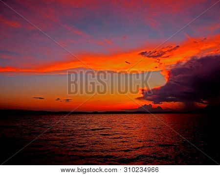 Red And Blue Dramatic Cloudy Sunset Sky Over The Lake Resembles A Celestial Fire, The Southern Urals