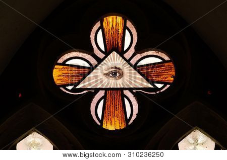 BRONNBACH, GERMANY - JULY 07, 2018: God's all-seeing eye, stained glass window in Cistercian Abbey of Bronnbach in Reicholzheim near Wertheim, Germany