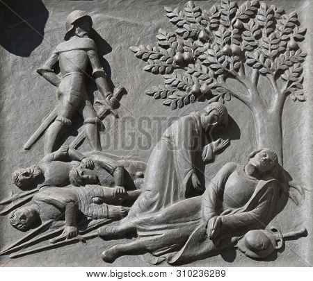 ZURICH, SWITZERLAND - JUNE 23, 2018: Zwingli's death on the battlefield at Kappel, 11 October 1531., relief on the door of the Grossmunster (