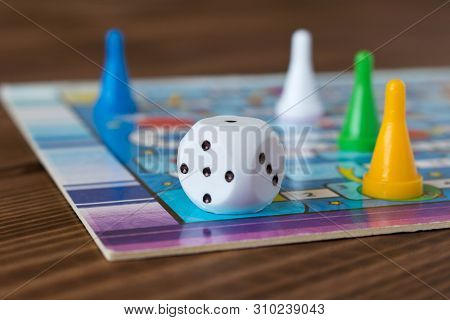 Multi-colored Game Chips With Dice On The Playing Board. Board Game.