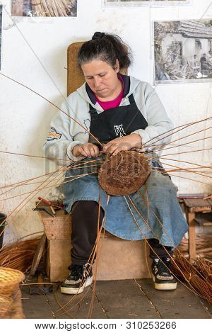 Camacha, Madeira, Portugal - April 19, 2018: A Basket Weaver At Work In The Factory Shop In Camacha 