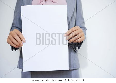 Cropped Image Of Female Entrepreneur Holding Blank White Paper Sheet