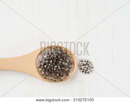 Wet Chia Seeds Or Chia-egg In Wooden Spoon On White Wooden Background. Egg Replacers, Plant Based Eg