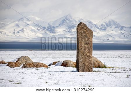 Traditional Memorable Stones On The Shore Of Son-kul Lake On The Background Of Snow-capped Mountains