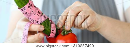 Culinary Chef Measure Green Cucumber Penis Size. Man In Apron With Tomato And Cucumber Wrapped In Ce