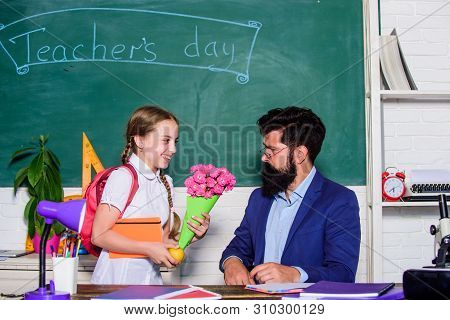 Flower Present For Best Teacher. Knowledge Day Is 1 September. Small School Girl Kid With Flower. Ba