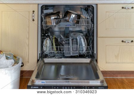 Russia, Tatarstan, May 31, 2019. Open Dishwasher With Dirty Dishes