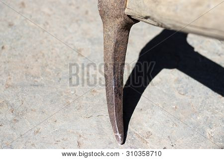 The Pickaxe Tool Hits The Stone. Extraction Of Stone And Iron Ore With A Hoe Or Pick With A Wooden H