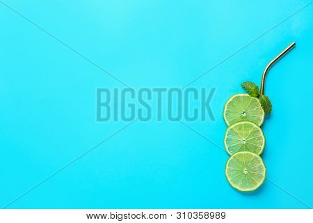 Creative Image Of Summer Cocktail Made With Lime Slices, Mint And Straw On Color Background, Top Vie