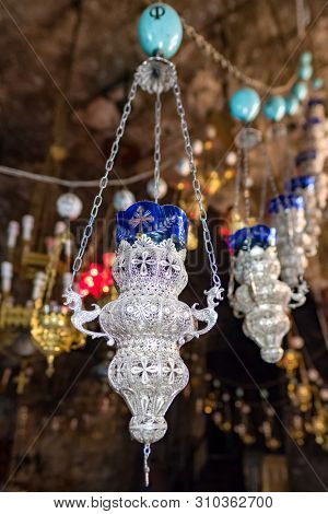 Old candle lamps at Church of the Sepulchre of Saint Mary, also Tomb of the Virgin Mary, a Christian tomb in the Kidron Valley in Jerusalem, Israel