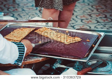 Turkish Woman Prepares Gozleme - Traditional Dish In The Form Of Flatbread Stuffed With Greens And C