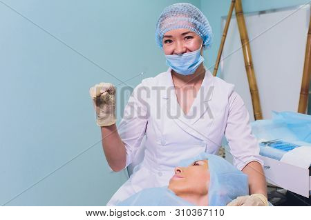 Aged Woman Doing Mesothreads And Thread Lifting, Cosmetology. Cosmetic Procedure To Eliminate Signs 
