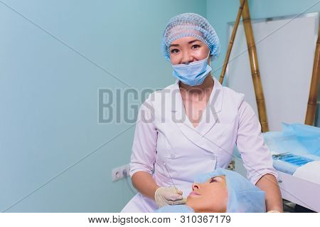 Aged Woman Doing Mesothreads And Thread Lifting, Cosmetology. Cosmetic Procedure To Eliminate Signs 