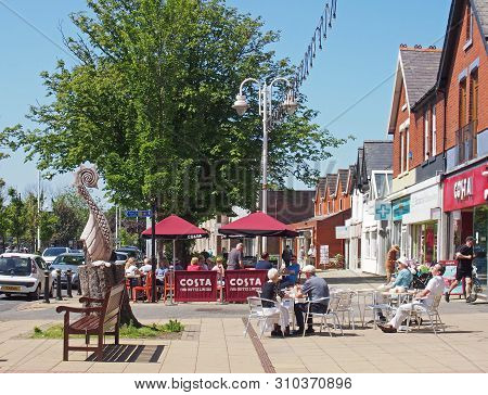 Formby, Merseyside, United Lingdom - 28 June 2019: People Sat Outside Cafes On The High Street In Su