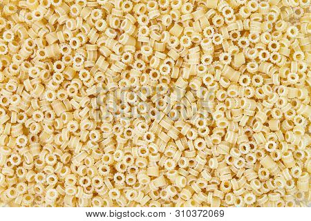 Close-up Shot Of Ditalini Italian Pasta. Pasta Background Pattern . Italian Food.