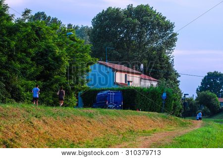 Rovigo, Italy - July, 2, 2019: people joging in Rovigo at sunset