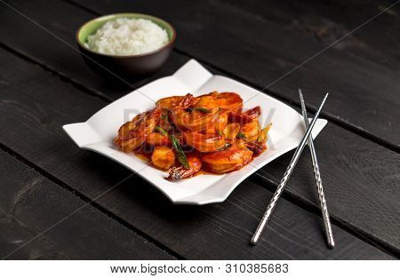 Ketchup Shrimp Plate On Dark Background. Ketchup Shrimp Plate With Bowl Of Rice And Chopsticks Angle