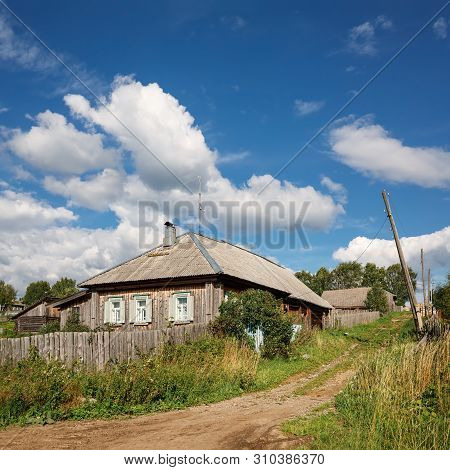View Of The Village Street With Old Wooden House On A Sunny Summer Day. Village Of Visim, Sverdlovsk