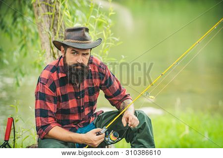 Trout On A Hook. Man Fly Fishing. Brown Trout Being Caught In Fishing Net. Fly Fisherman Using Fly F