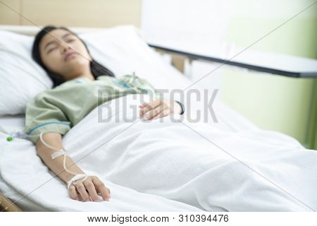 Asian Lady Sleep And Patient In Hospital With Iv Solution, This Immage Can Use For Flu, Sick, Health